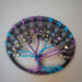 top view tree showing off blue and purple twisted branches adornd with glass beads